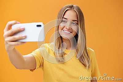 Waist-up shto of outgoing and charismatic pretty confident woman with no makeup and tanned skin holding smartphone Stock Photo