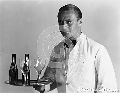 Waiter with beverages on tray Stock Photo