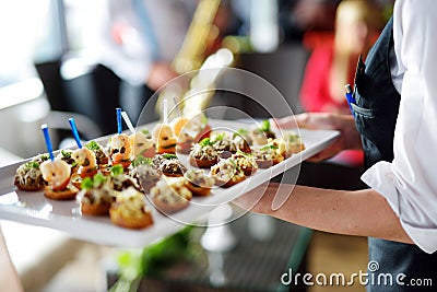 Waiter carrying plates with meat dish Stock Photo