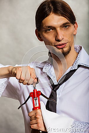 Waiter opens wine bottle. Stock Photo