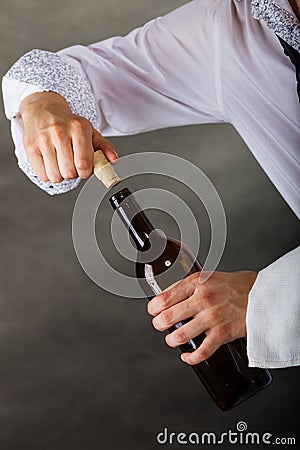 Waiter opens wine bottle. Stock Photo