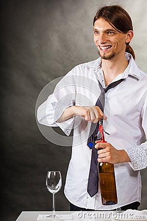 Waiter opens wine bottle. Stock Photo