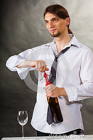 Waiter opens wine bottle. Stock Photo