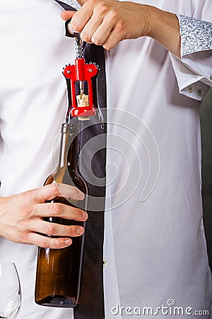 Waiter opens wine bottle. Stock Photo