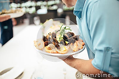 shrimp in the hand of the waiter Stock Photo