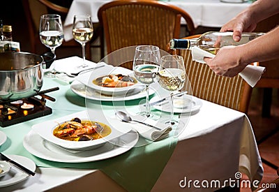 Waiter Serving Food at Restaurant Stock Photo