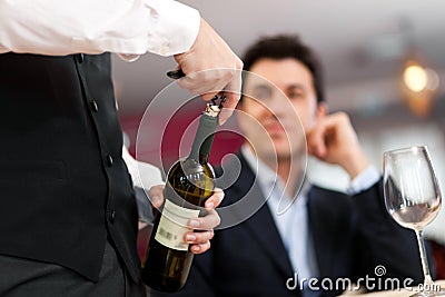Waiter serving wine Stock Photo