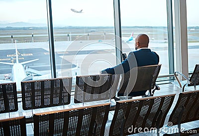 Waiting, airport and black man on a phone rest for travel, plane and air flight. Businessman, mobile connection and Stock Photo