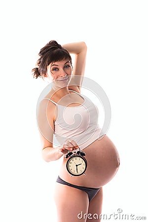 Waiting for the baby, bright funny pregnant woman with clock, Stock Photo