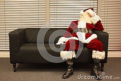 Waiting for christmas job, santa claus sleeping on sofa Stock Photo