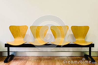 Waiting room with empty wooden chairs, concept of waiting and passage of time, free space for text Stock Photo