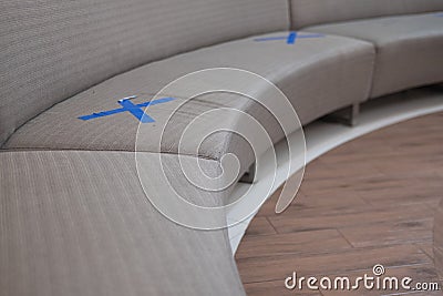 Waiting sofa with symbol on seat for the social distancing Stock Photo