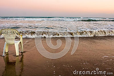 Waiting for the Summer lonely chair at the coast of the Mediterranean sea, Cyprus Stock Photo