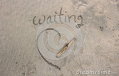 The waiting word on the sand from beach Stock Photo