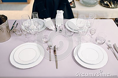 Waitress in gloves puts the knife, table setting Stock Photo