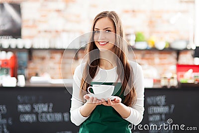 Waitress holding cup of coffee Stock Photo