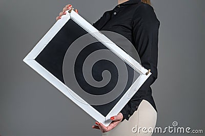 Waitress holding tilted chalkboard Stock Photo