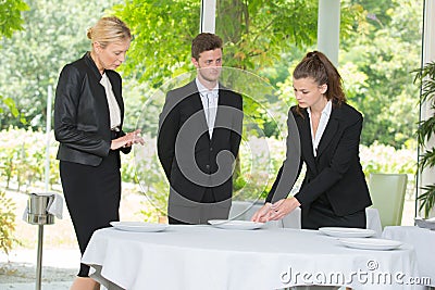 Waitress learning how to prepare table Stock Photo