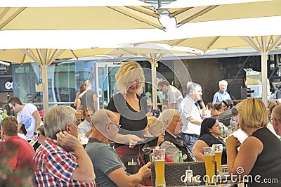 Waitress in a Restaurant terrace Editorial Stock Photo