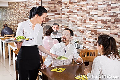 Waitress taking table order at tavern Stock Photo