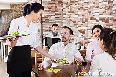 Waitress taking table order at tavern Stock Photo