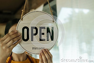 waitress woman wearing protection face mask turning sign board Stock Photo