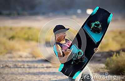 Wake boarding sportsman jumping high trick with big water splash in the cable park, active water sports Stock Photo