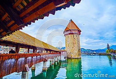Walk along covered wooden Kapellbrucke Chapel Bridge in Lucerne, Switzerland Stock Photo