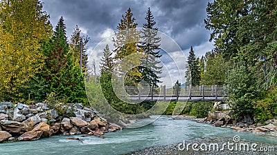 Walk Bridge over the Turquoise Waters of Fitzsimmons Creek at the Village of Whistler Editorial Stock Photo