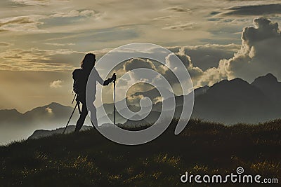 Walk in solitude on the Alps. A woman on with the background of Stock Photo