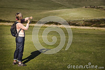 Walker looking at fitbit on grass Editorial Stock Photo