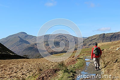 Walker on mountain footpath in Lake District Stock Photo