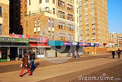 Walkers stroll the boardwalk in Brighton Beach Editorial Stock Photo