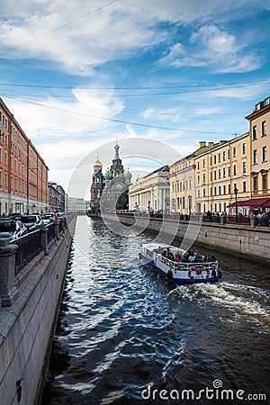 walking boat moves through the channel Griboyedov on the background Church of the Savior on Blood Editorial Stock Photo