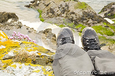 Walking boots with beach in background Stock Photo