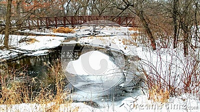 Walking Bridge Crossing Over Icy River Stock Photo