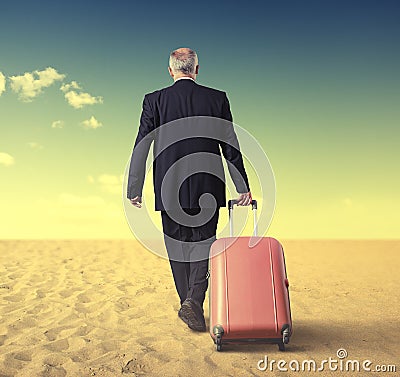 Walking businessman with suitcase in a desert Stock Photo