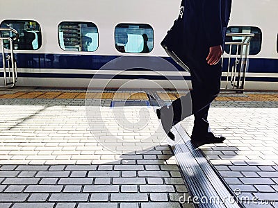 A man walking on the train station background Stock Photo