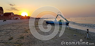 Walking catamaran against the backdrop of sunrise on the sea. Stock Photo