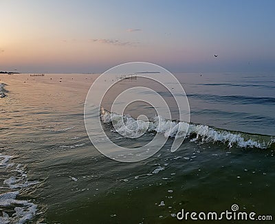 Walking catamaran against the backdrop of sunrise on the sea. Stock Photo