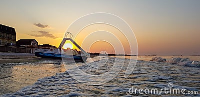 Walking catamaran against the backdrop of sunrise on the sea. Stock Photo