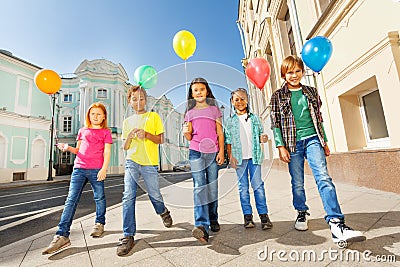 Walking children diversity with colorful balloons Stock Photo
