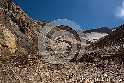 Walking into the crater of Mutnovsky Volcano on ash covered eternal snow Stock Photo