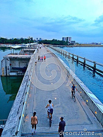 Walking and cycling on Marina Barrage Editorial Stock Photo