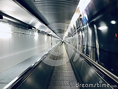Walking escalators in an airport tunnel unique photo Stock Photo