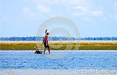 Walking with low waters and ollecting mussels in Mozambique coast Editorial Stock Photo