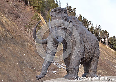 Walking mammoth against precipice Stock Photo