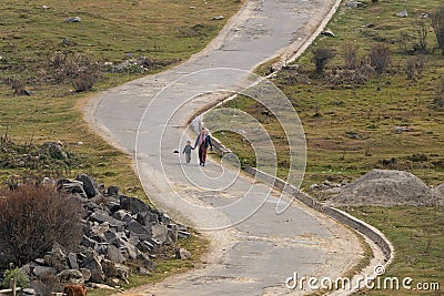 Walking mother & son by road at Bhutan Editorial Stock Photo