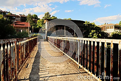 Walking over an abandoned dam on the Yantra River, rusted, rusty railings, handrails, rails on both sides of the concrete bridge, Stock Photo