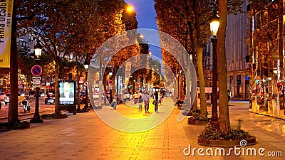 Walking over the Champs Elysee Avenue in Paris by night - CITY OF PARIS, FRANCE - SEPTEMBER 04, 2023 Editorial Stock Photo